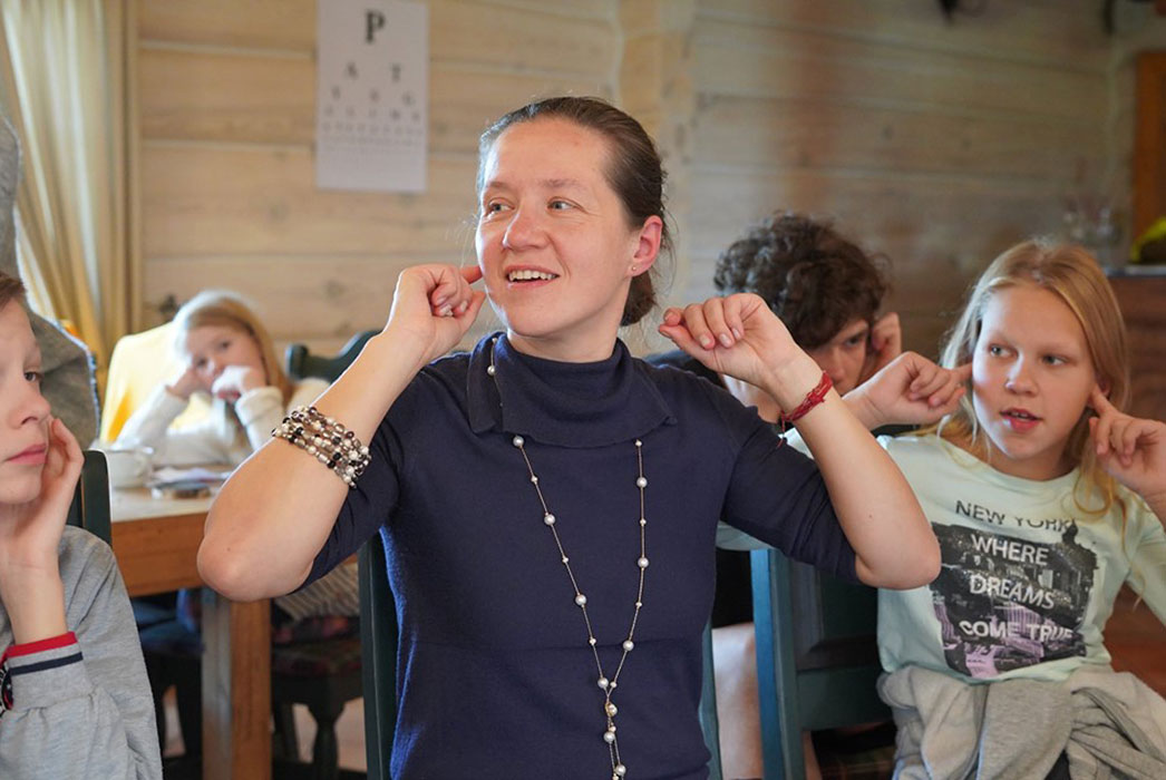 Sigita instructing a class in massaging points around the head